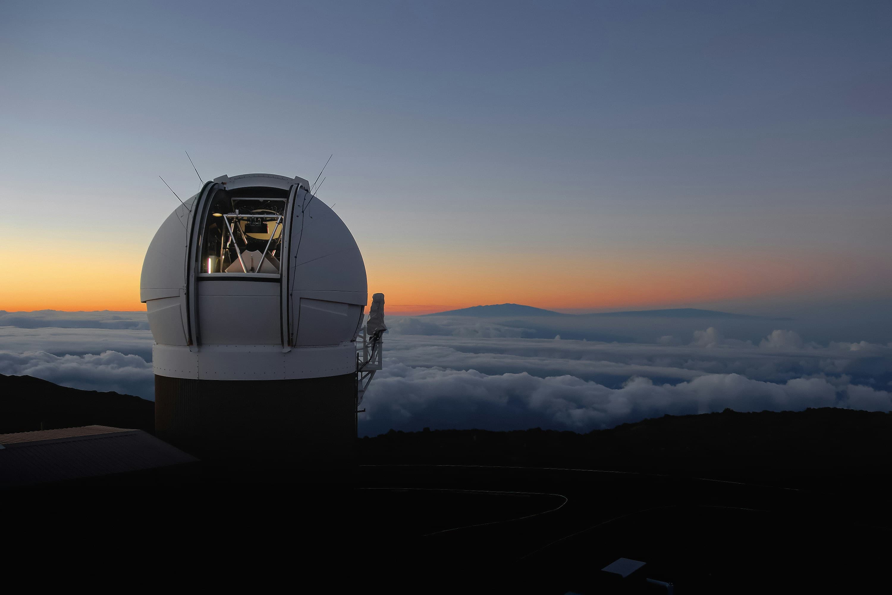 Observatory dome under a star-filled Hawaiʻi night sky